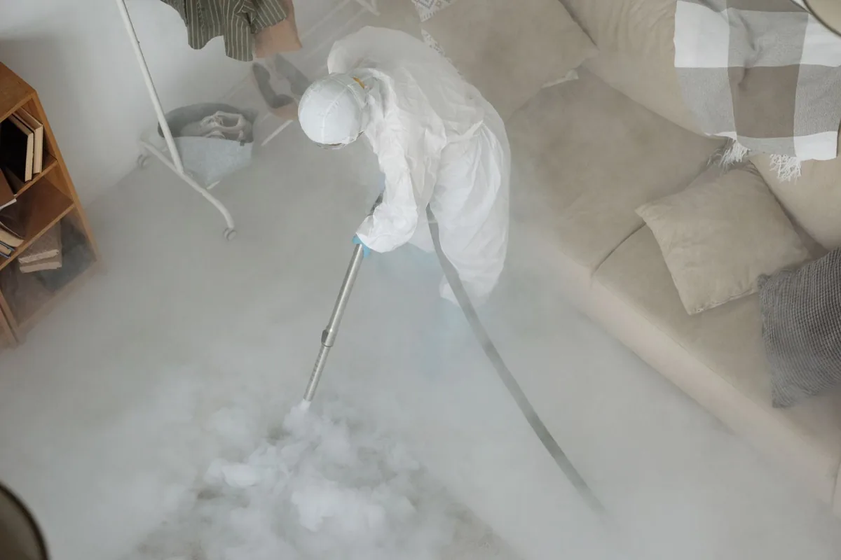 Biohazard cleanup technician in protective equipment, Central, LA